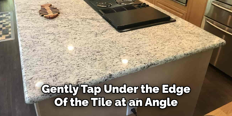 Gently Tap Under the Edge
Of the Tile at an Angle