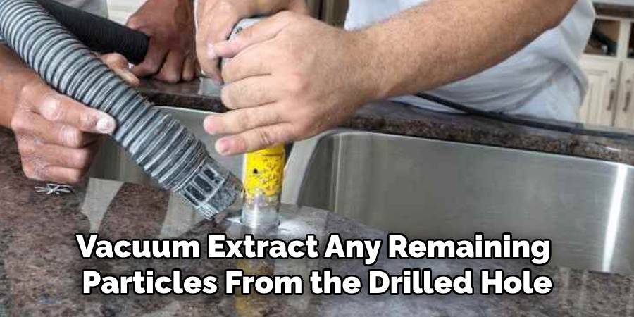 Vacuum Extract Any Remaining
Particles From the Drilled Hole