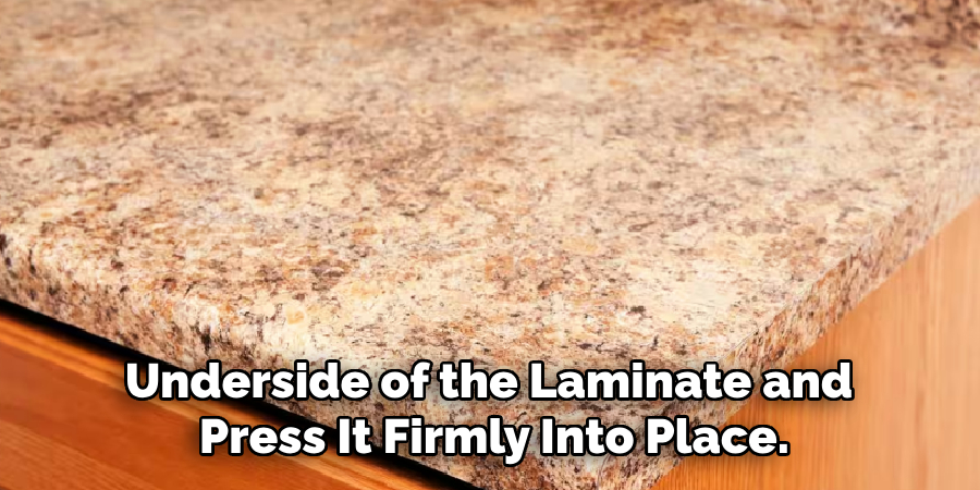 underside of the laminate and press it firmly into place